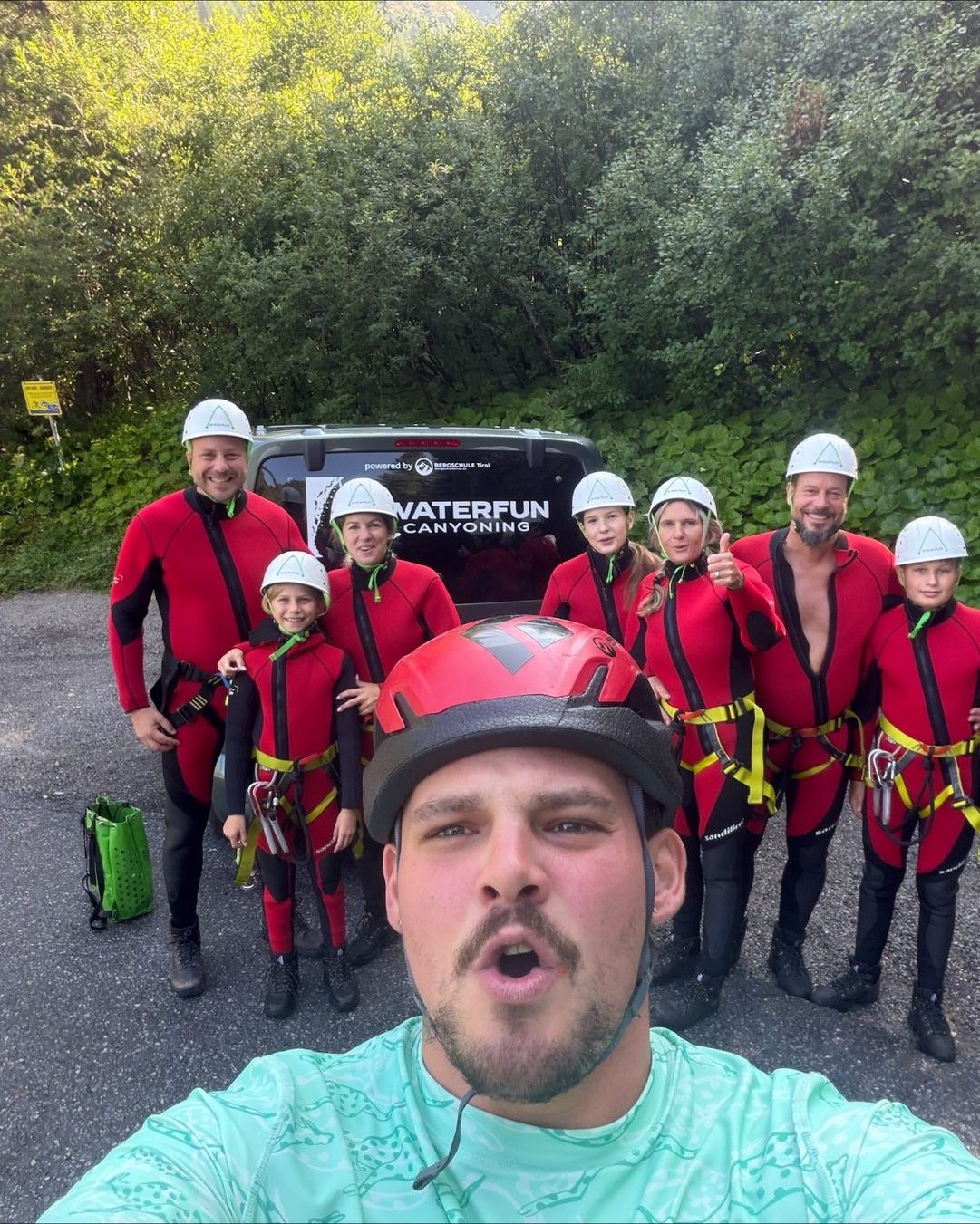 Guide in canyoning gear with his group before the start of the tour
